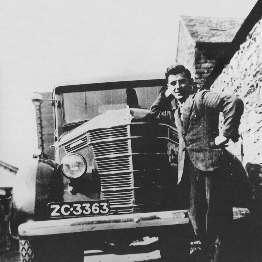 CRH co-founder Tom Roche leaning against a truck in 1930s Ireland